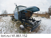 Zhukovka, Bryansk region, Russia - January 5, 2020: Landfill of old cars. Winter landscape. Snowfall. Destroyed cars. Aging process concepts. Theme of waste disposal. Редакционное фото, фотограф YuryKara / Фотобанк Лори