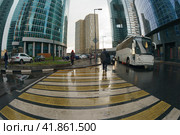 Moscow, Russia - September 18, 2019: Workout time. Working day had been finished, people leave office. MIBC Moscow International Business Center. Rain autumn business concepts. Fish-Eye technique lens. Редакционное фото, фотограф YuryKara / Фотобанк Лори