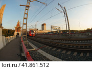 Moscow, Russia - September 26, 2019: Photography of train of Moscow Central Circle / MCC. Fashionable and comfortable Lastochka commuter train in the motion. Academy of Sciences in distance. Fish eye. Редакционное фото, фотограф YuryKara / Фотобанк Лори