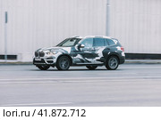 BMW X3 SUV car wrapped in vinyl foil or film on the city road. Fast moving vehicle on Moscow streets. Compliance with speed limits on the road. Редакционное фото, фотограф Константин Григорьев / Фотобанк Лори