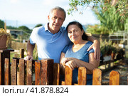 Portrait of happy content adult couple near fence of their farm. Стоковое фото, фотограф Яков Филимонов / Фотобанк Лори