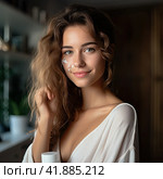 A young beautiful girl with gorgeous hair in a light T-shirt looks at the camera and smiles. Generated by And. Стоковое AI-изображение, AI-художник Ярославский Максим / Фотобанк Лори