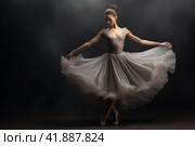 A young graceful ballerina dressed in a weightless skirt demonstrates her dancing skills. Стоковое AI-изображение, AI-художник Виктория Тельминова / Фотобанк Лори