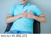 Heart attack, man with chest pain suffering at home, myocardial infarction. Стоковое фото, фотограф Станислав Тарко / Фотобанк Лори