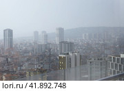 The view from the skyscraper window to the Asian part of Istanbul. City development in a haze. On the horizon of mountains and hills. (2023 год). Стоковое фото, фотограф Vadzim Yakubovich / Фотобанк Лори