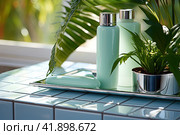 Tubes and jars of skin care and tanning products are located near the pool. The concept of skin care. Generated by AI. Стоковое AI-изображение, AI-художник Ярославский Максим / Фотобанк Лори