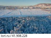 Winter aerial view of the northern city and its surroundings. The nature of Siberia and the Russian Far East. Beautiful snowy forest. Cold winter weather. Magadan city, Magadan region, Russia. Стоковое фото, фотограф Андрей Степанов / Фотобанк Лори