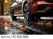 Studded tires. Car standing on a wet dangerous road in autumn during rain. Close up. Autumn vacation concept. Стоковое AI-изображение, AI-художник Ирина Михайличенко / Фотобанк Лори