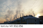 Smoke and steam from the chimneys of residential multi-storey buildings rises in severe frost -27 degrees Celsius. Housing and communal services and heating. Panel and brick housing construction. (2017 год). Редакционное видео, видеограф Юлия Петровская / Фотобанк Лори