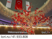 Istanbul, Turkey 12.31.23: international airport Istanbul Havalimani IST. New Year and Christmas decorations, garlands, small architectural forms. Multi-colored light bulbs create festive atmosphere. Редакционное фото, фотограф Юлия Петровская / Фотобанк Лори