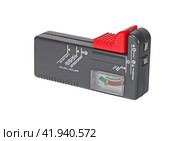Измеритель заряда батареек на белом фоне. Meter battery tester batteries batteriemessger. Стоковое фото, фотограф Татьяна Д / Фотобанк Лори