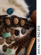 handmade stone runes on white fur. Стоковое фото, фотограф Boris Vasilenko / Фотобанк Лори