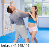 Self-defense training - woman practicing blows to the head of male attacker. Стоковое фото, фотограф Яков Филимонов / Фотобанк Лори
