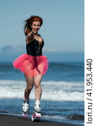 Fit woman in sports Kangoo Jumps boots, one-piece swimsuit and short pink skirt running and jumping on sandy beach during fitness session workout (2022 год). Редакционное фото, фотограф А. А. Пирагис / Фотобанк Лори