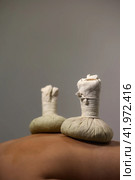 Health herbal massaging, herb compresses bag lying on woman back, spa room at shadow, Thai method massage. Relaxing massage of lady back at salon. Relax spa massaging concept. Copy ad text space. Стоковое фото, фотограф Aleksandr Golubev / Фотобанк Лори
