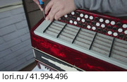 The man fasten with screws the right cover of the button accordion. Bayan repair and maintenance. Стоковое видео, видеограф Vadzim Yakubovich / Фотобанк Лори