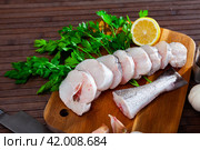 Steaks of raw walleye pollock with condiments and greens. Стоковое фото, фотограф Яков Филимонов / Фотобанк Лори
