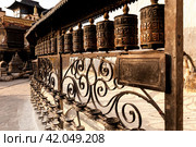 Tibetan prayer wheels made from metal at Swayambhunath Temple - Monkey Temple, Kathmandu, Nepal (2015 год). Стоковое фото, фотограф VittoriaChe / Фотобанк Лори