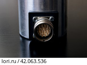 Metal encoder on a black wooden table. Стоковое фото, фотограф Аксенова Вера / Фотобанк Лори