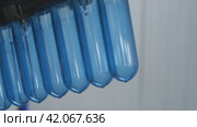 Preforms for five-liter bottles are sent to the blowing machine. Production of plastic bottles at the mineral water bottling plant. Стоковое видео, видеограф Воловодов Владимир / Фотобанк Лори