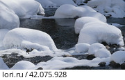 Video of Stones with snow caps and ice in the water of frozen river Pescherka near waterfall in winter season. Russia. Стоковое видео, видеограф Сергей Пристяжнюк (Serg Zastavkin) / Фотобанк Лори