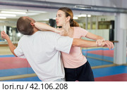 Young woman practicing elbow blow with wristlock to opponent in gym. Стоковое фото, фотограф Яков Филимонов / Фотобанк Лори