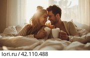 Young loving couple in the bed with cops of coffee. soft and light colors. copy space. Стоковое AI-изображение, AI-художник Юлия Гапеенко / Фотобанк Лори