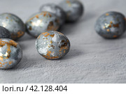 Stylish grey Easter eggs made of marble and concrete with a golden potala on a grey background. Coloring eggs with natural dye karkade tea. . The concept of a happy Easter. Стоковое фото, фотограф Photojuli / Фотобанк Лори