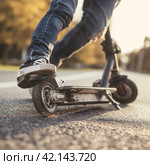 Man falling off an electric scooter. Стоковое AI-изображение, AI-художник Кирилл Черезов / Фотобанк Лори