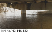 Flooding. Water in the river rose to the top of the car bridge. Concrete pillars under water. Muddy river after heavy rain. Natural disasters. A weather disaster. Environmental disaster. Стоковое видео, видеограф Воловодов Владимир / Фотобанк Лори