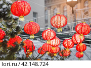 Chinese red Christmas lanterns on Tverskaya Street in Moscow. Close-up. The first ever meeting of the Chinese New Year 2024 in Moscow. Стоковое фото, фотограф Photojuli / Фотобанк Лори