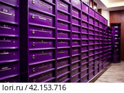 Purple steel Mailboxes in an apartment residential building inside. Modern rows of numbered mailbox, creative design mail backgrounds. Urban correspondence concept. Copy ad text space. Generated Ai. Стоковое AI-изображение, AI-художник Aleksandr Golubev / Фотобанк Лори