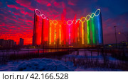The Olympic rings on a city street. Olympic games concept. Стоковое AI-изображение, AI-художник Ирина Михайличенко / Фотобанк Лори