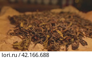 A scattering of dried tea lying on brown parchment. Стоковое видео, видеограф Даниил Хабаров / Фотобанк Лори