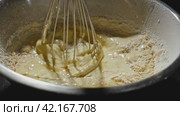 The process of making dough from flour, milk and chicken eggs. The whisk whips the dough. Whisking Dough with Flour, Milk, and Eggs. Стоковое видео, видеограф Даниил Хабаров / Фотобанк Лори