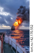 Fire on an offshore oil tanker. Стоковое AI-изображение, AI-художник Кирилл Черезов / Фотобанк Лори