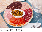 Slices of Spanish dry-cured gammon, variety of sausages. Стоковое фото, фотограф Яков Филимонов / Фотобанк Лори