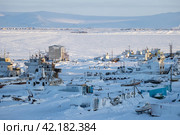 Winter arctic landscape. A view of the snow-covered berths and winter anchorage of ships, barges, yachts and boats on the coast of the frozen estuary. Alexander Spit, Anadyr, Chukotka, Siberia, Russia. Стоковое фото, фотограф Андрей Степанов / Фотобанк Лори