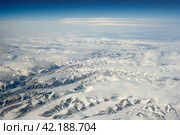 Aerial photography. View of the mountains covered with snow. In the sky above the mountains are clouds. Ilirney Ridge, Chukotka, Siberia, the Far East of Russia. Photo can be used for background. Стоковое фото, фотограф Андрей Степанов / Фотобанк Лори