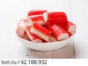 Salad crab sticks in a plate on a white table. Стоковое фото, фотограф Глущенко Елена / Фотобанк Лори
