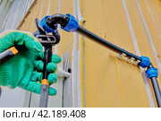 Installation of an external irrigation water supply, joining pipes using elbow compression fittings, plumber tightens collet nut. Стоковое фото, фотограф Владимир Григорьев / Фотобанк Лори