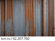 Old industrial corrugated iron industrial texture wall made of tin sheets. Grunge metal plate background. Copy ad text space. Стоковое AI-изображение, AI-художник Aleksandr Golubev / Фотобанк Лори