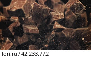 Chunks of chocolate fly up and fall down. Filmed on a high-speed camera at 1000 fps. Стоковое видео, видеограф Артем Шадрин / Фотобанк Лори