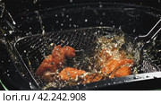 Chicken nuggets fall into hot oil. Filmed on a high-speed camera at 1000 fps. Стоковое видео, видеограф Артем Шадрин / Фотобанк Лори