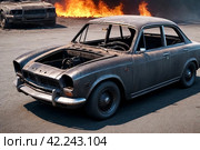 Close-up completely burnt out and carbonized car. Vehicle blown up by military shell burned abandoned automobile during war operations. Copy space. Стоковое AI-изображение, AI-художник Aleksandr Golubev / Фотобанк Лори