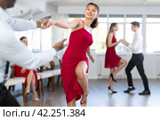 Woman in red dress practicing playful jitterbug in dance studio. Стоковое фото, фотограф Яков Филимонов / Фотобанк Лори