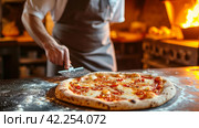 A pizzaiolo expertly sliding a pizza peel under a freshly baked pizza, ready for slicing. Стоковое AI-изображение, AI-художник Юлия Гапеенко / Фотобанк Лори