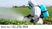 use of pesticides to protect crops is increasing in developed countries. Стоковое AI-изображение, AI-художник Юлия Гапеенко / Фотобанк Лори