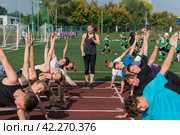 Female coach and group of children conducts a training session. Стоковое фото, фотограф Jan Jack Russo Media / Фотобанк Лори