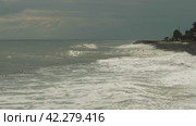 A view from the shore over a rough and stormy sea. Waves and foam on the shore during bad weather. The beautiful Black Sea with big waves. Стоковое видео, видеограф Воловодов Владимир / Фотобанк Лори